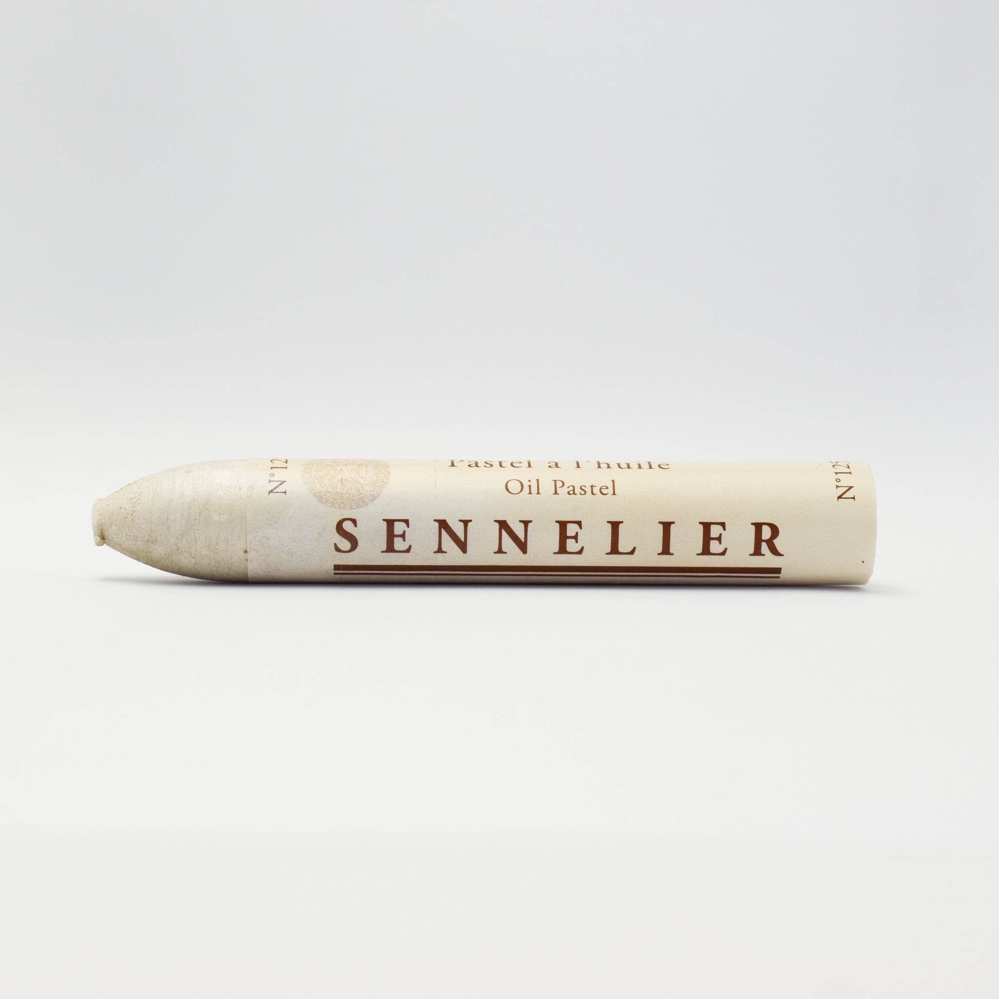 A single Sennelier oil pastel crayon against a white background, displaying the brand name and the word 'Oil Pastel' on the wrapper.