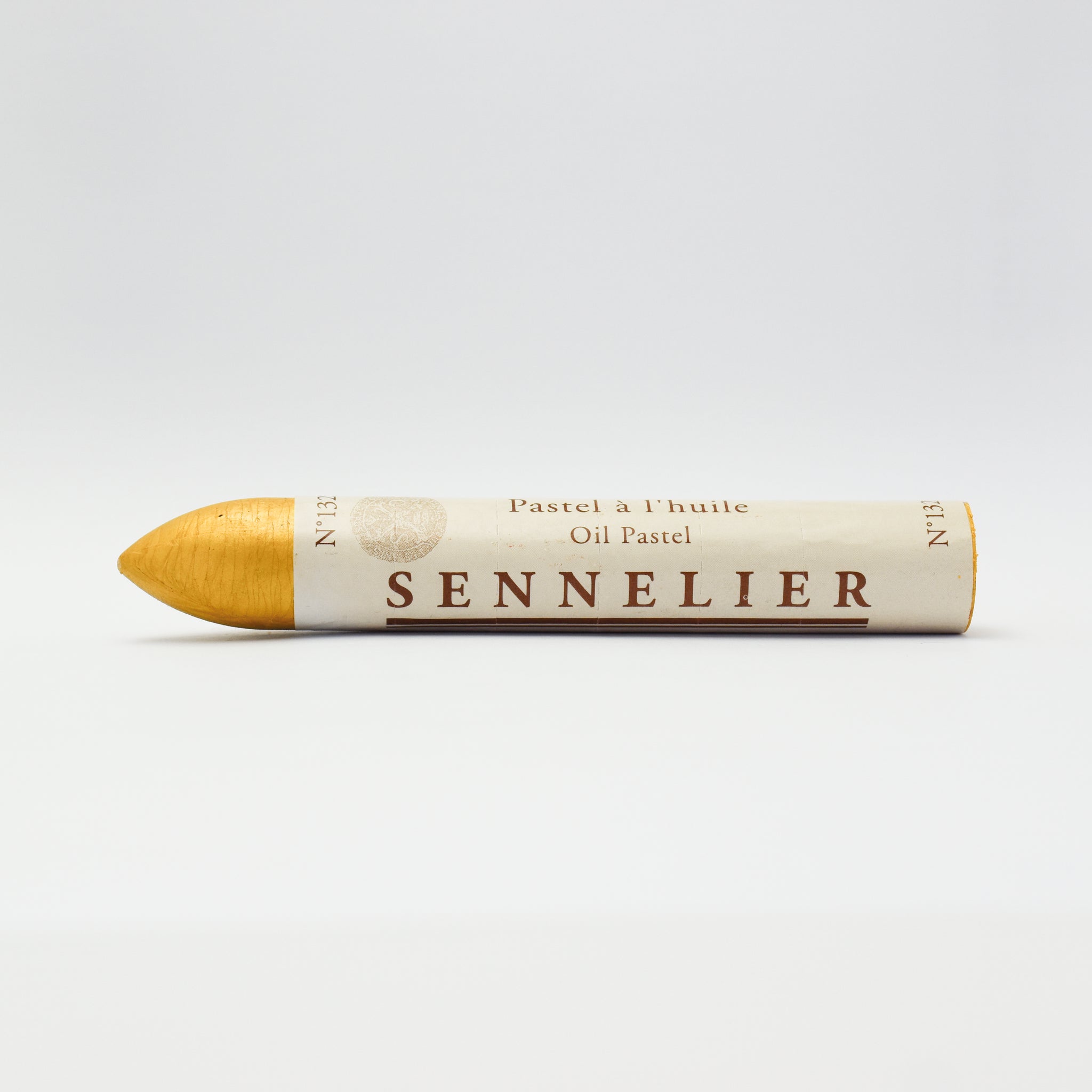 A single Sennelier oil pastel crayon against a white background, displaying the brand name and the word 'Oil Pastel' on the wrapper.