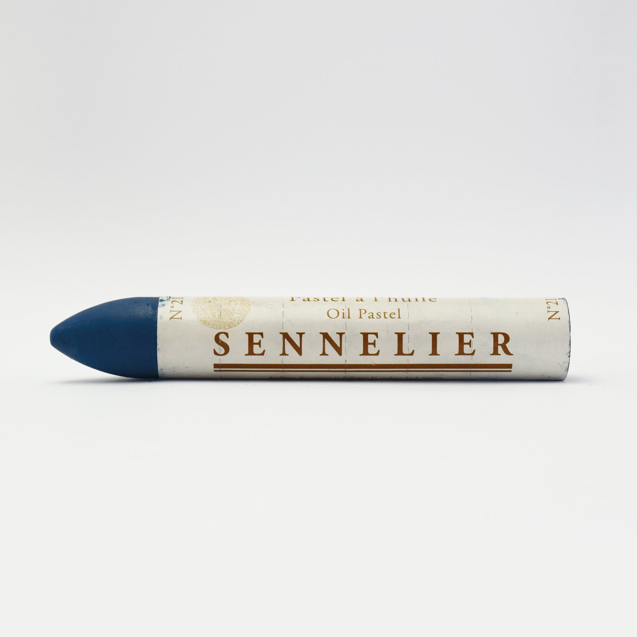 A single Sennelier oil pastel crayon against a white background, displaying the brand name and the word 'Oil Pastel' on the wrapper.