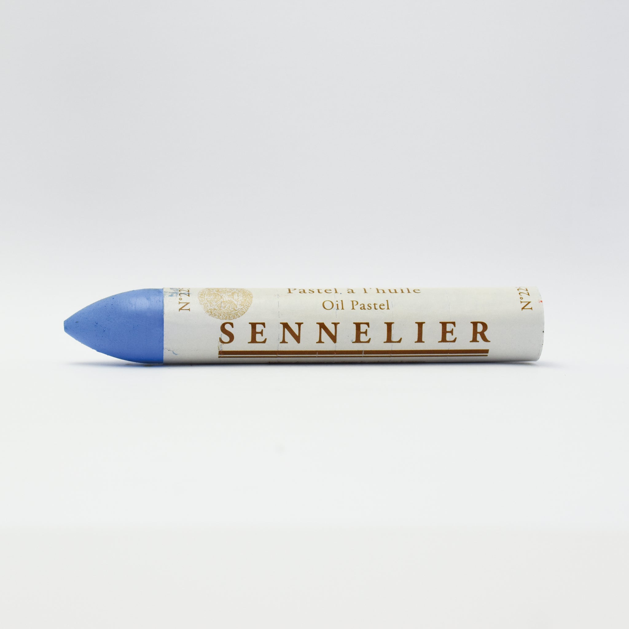 A single Sennelier oil pastel crayon against a white background, displaying the brand name and the word 'Oil Pastel' on the wrapper.