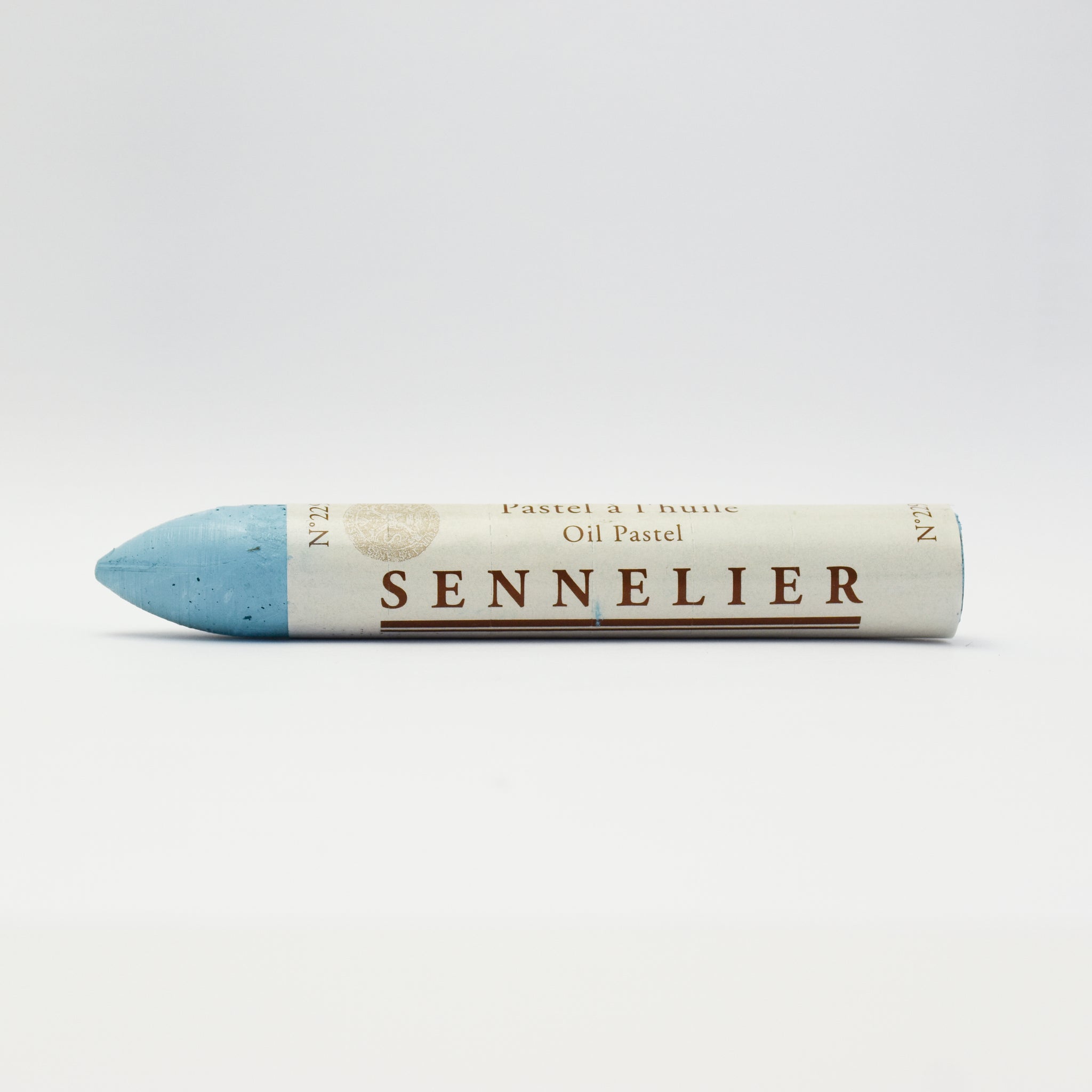 A single Sennelier oil pastel crayon against a white background, displaying the brand name and the word 'Oil Pastel' on the wrapper.