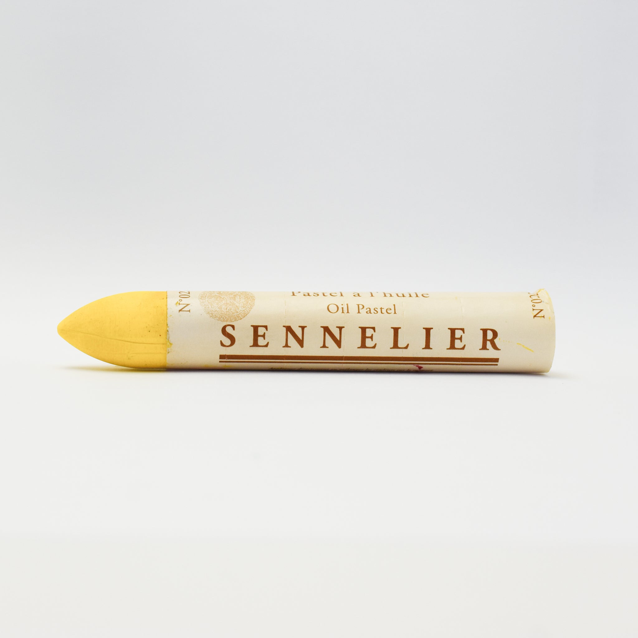 A single Sennelier oil pastel crayon against a white background, displaying the brand name and the word 'Oil Pastel' on the wrapper.