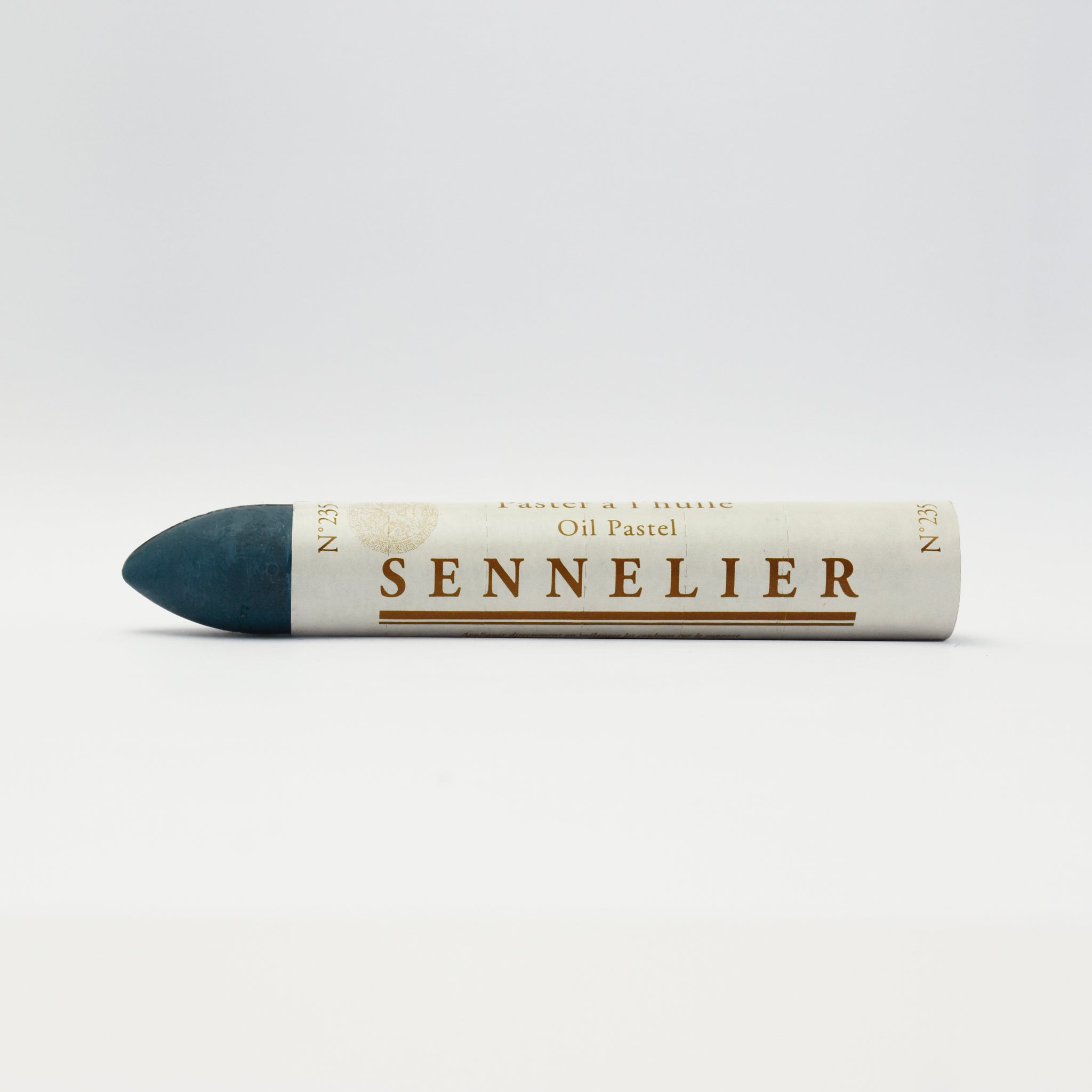 A single Sennelier oil pastel crayon against a white background, displaying the brand name and the word 'Oil Pastel' on the wrapper.