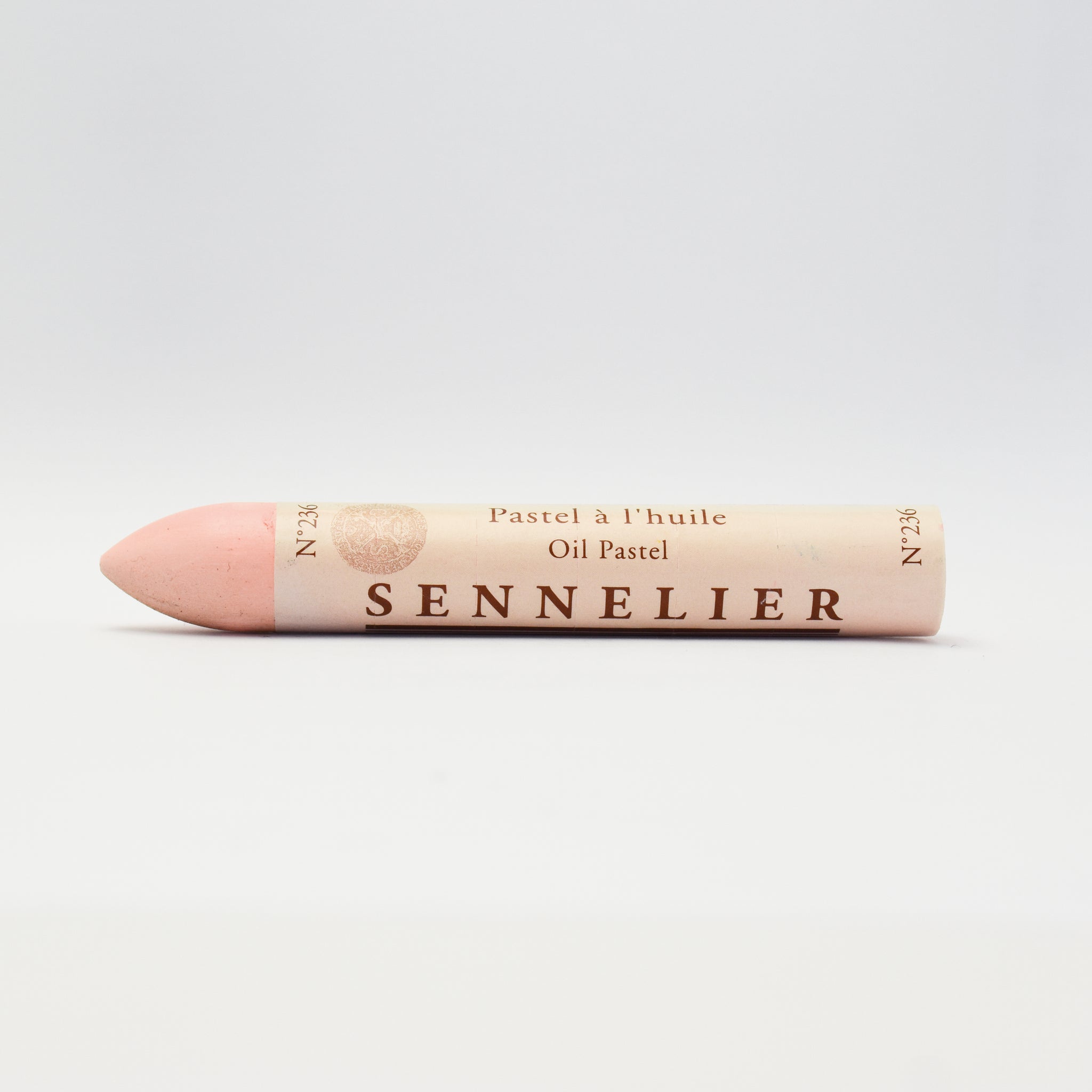 A single Sennelier oil pastel crayon against a white background, displaying the brand name and the word 'Oil Pastel' on the wrapper.
