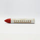 A single Sennelier oil pastel crayon against a white background, displaying the brand name and the word 'Oil Pastel' on the wrapper.