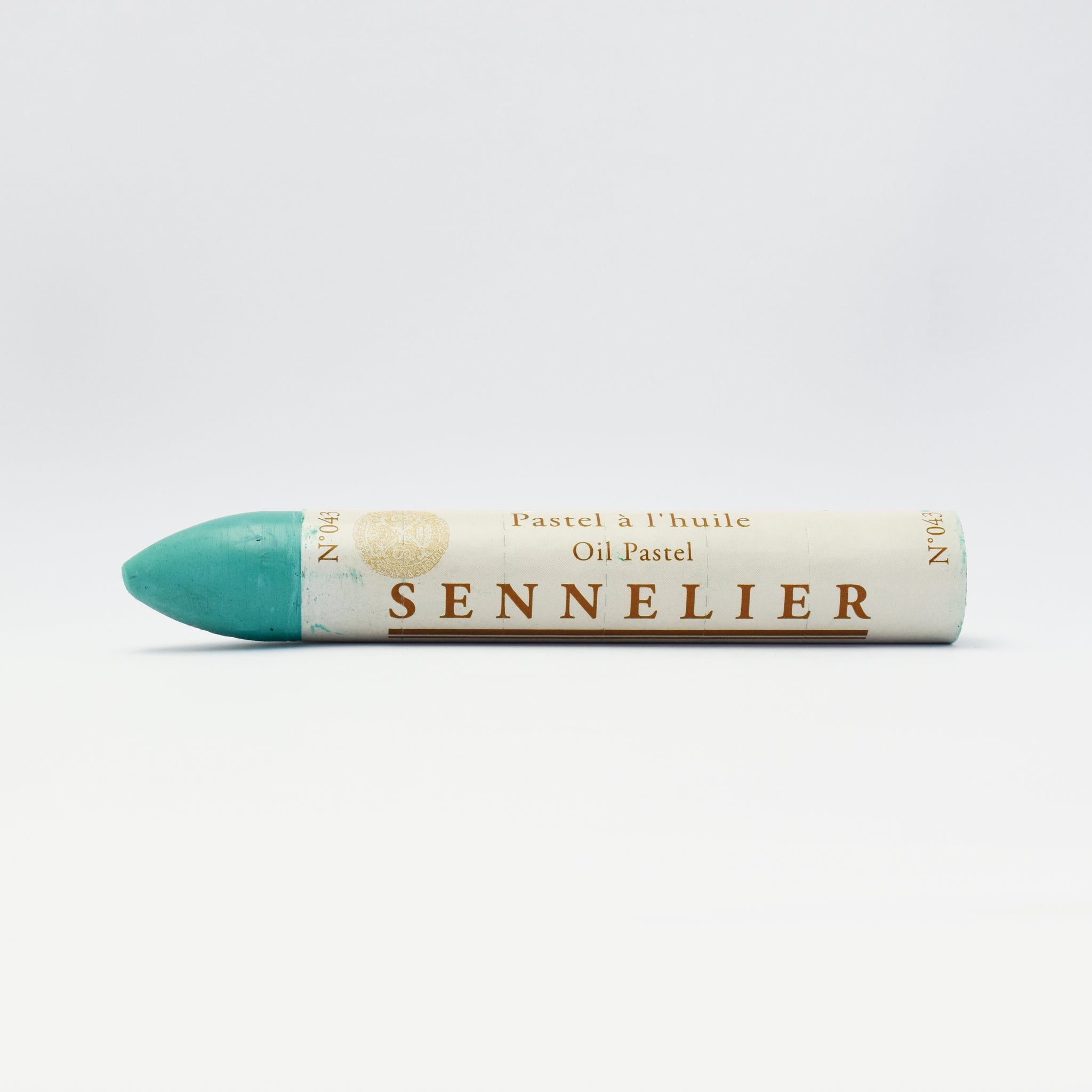 A single Sennelier oil pastel crayon against a white background, displaying the brand name and the word 'Oil Pastel' on the wrapper.