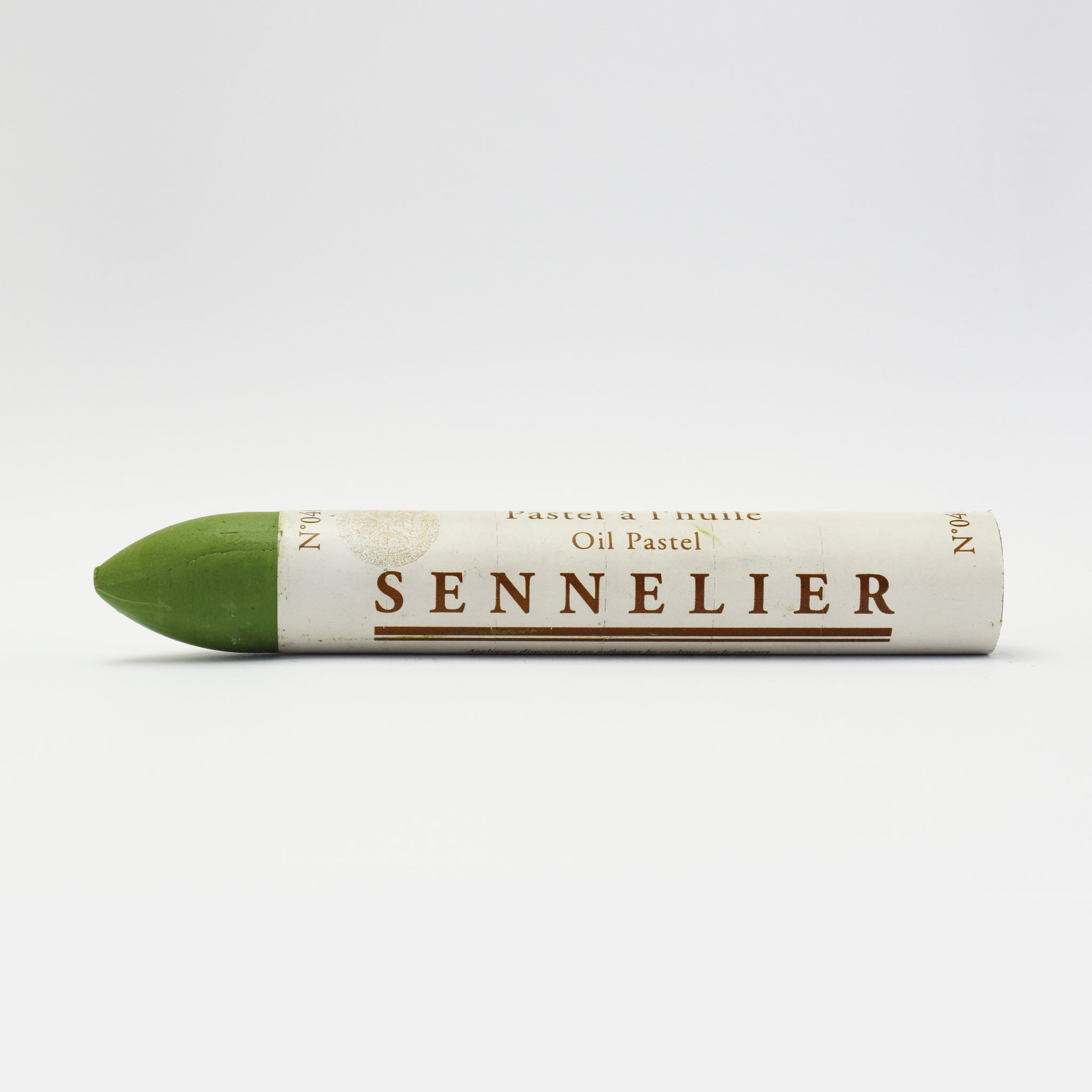 A single Sennelier oil pastel crayon against a white background, displaying the brand name and the word 'Oil Pastel' on the wrapper.