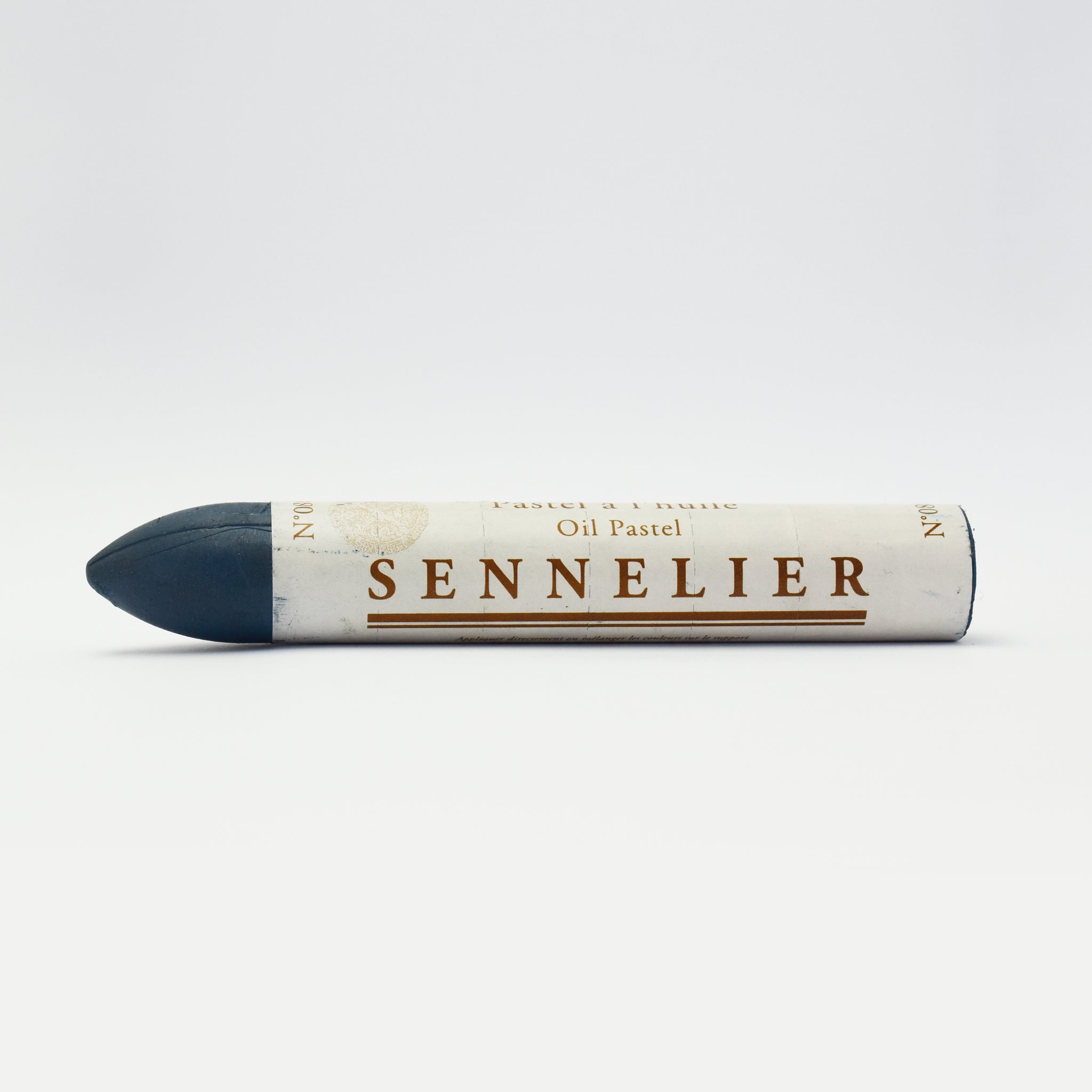 A single Sennelier oil pastel crayon against a white background, displaying the brand name and the word 'Oil Pastel' on the wrapper.