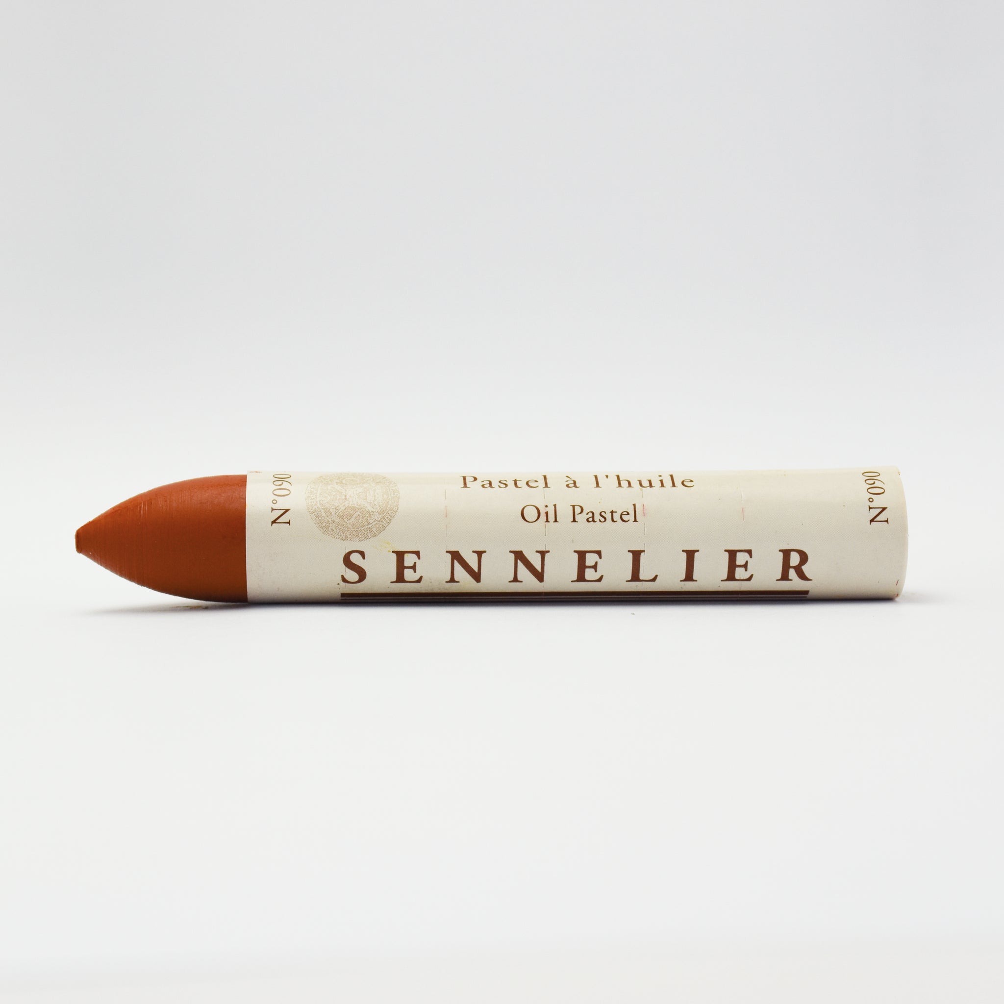 A single Sennelier oil pastel crayon against a white background, displaying the brand name and the word 'Oil Pastel' on the wrapper.