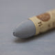 A close-up of a Sennelier oil pastel on a Grey background.