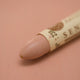 A close-up of a Sennelier oil pastel on a pink background.