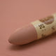 A close-up of a Sennelier oil pastel on a Pink background.
