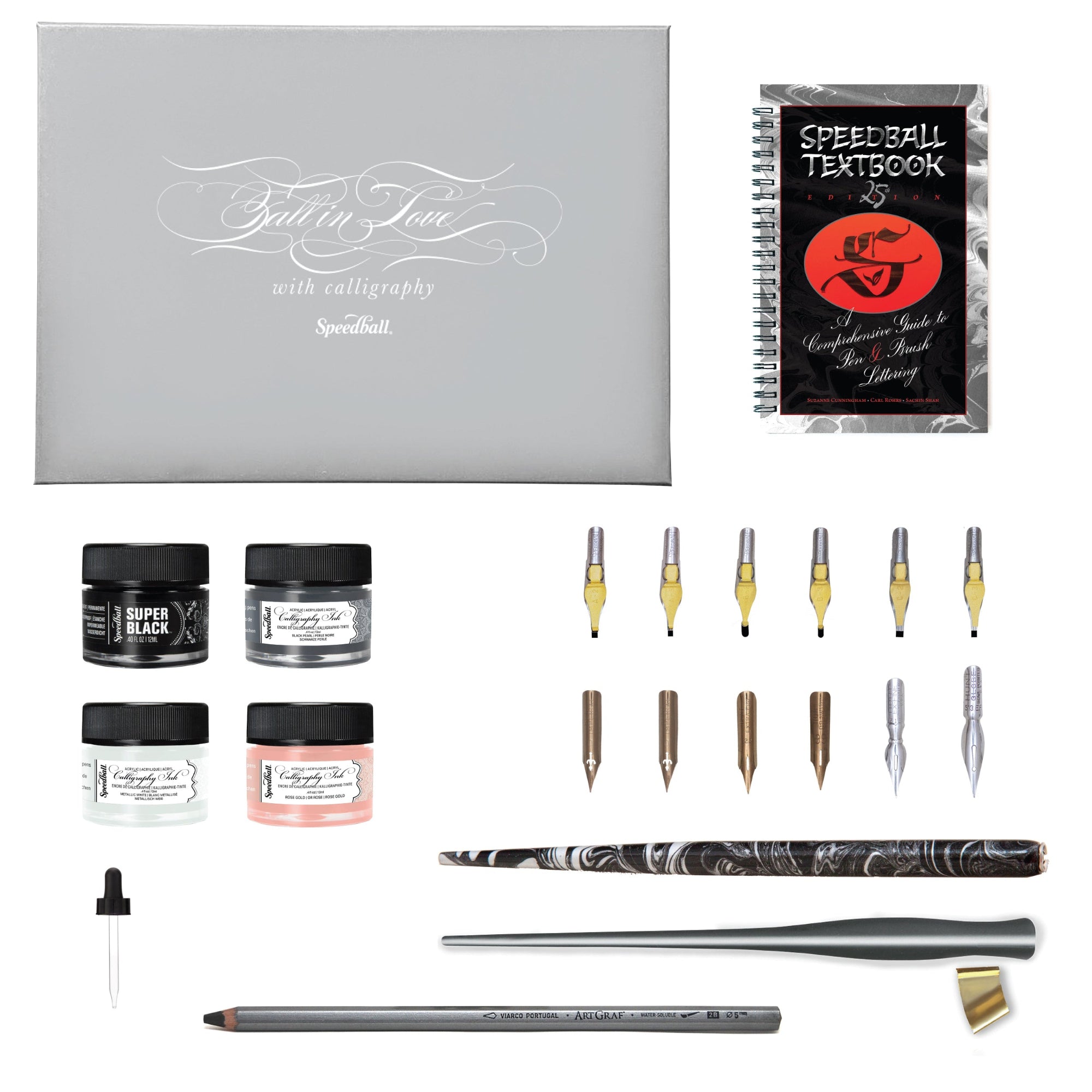 Collection of calligraphy kit supplies including ink pots, nibs, and a Speedball textbook, shown with a grey box on a white background.