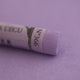  A close-up of a purple Sennelier extra soft pastel on the same coloured background, with the colour information printed on the paper wrap.