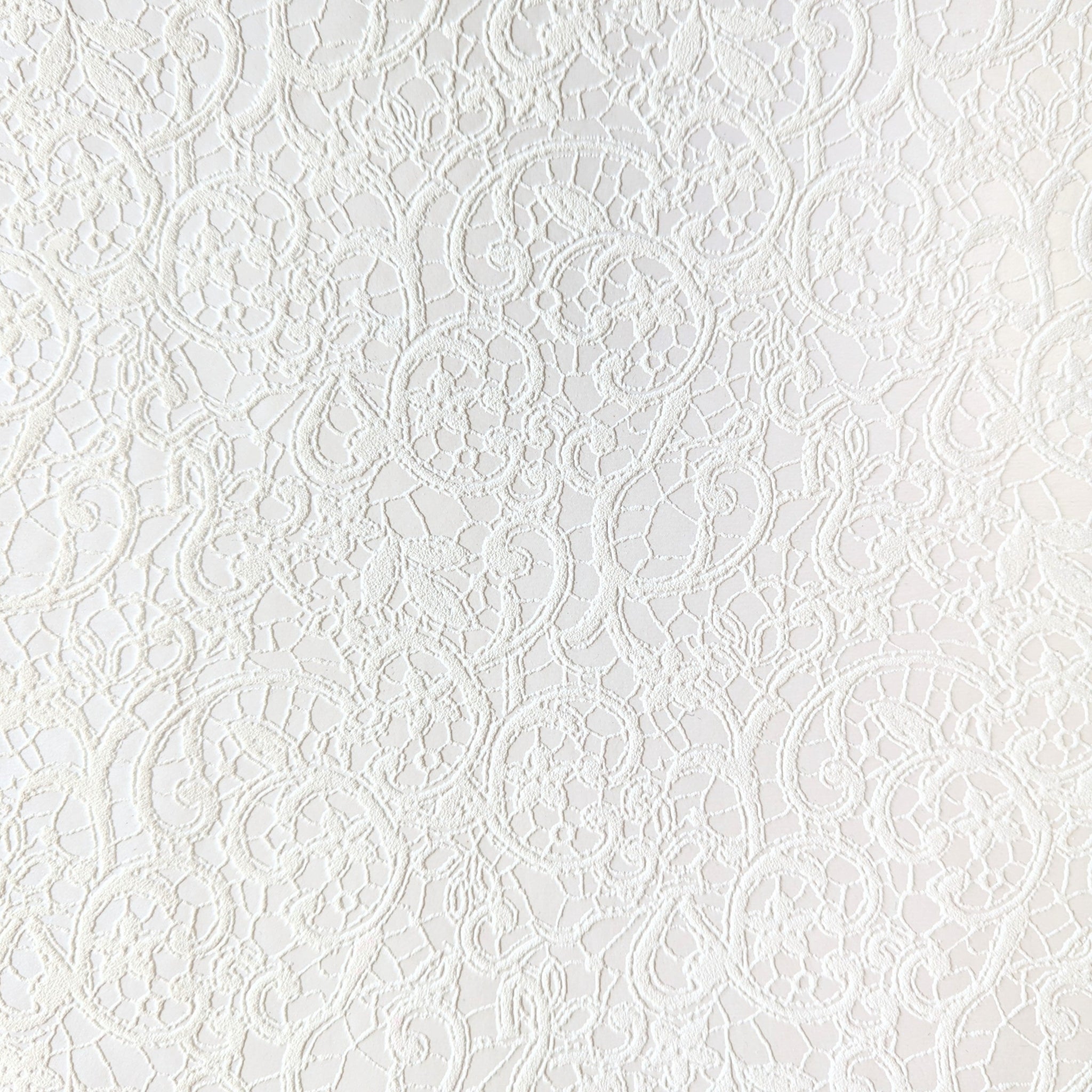 A Swatch of white book cloth with a raised floral design. 
