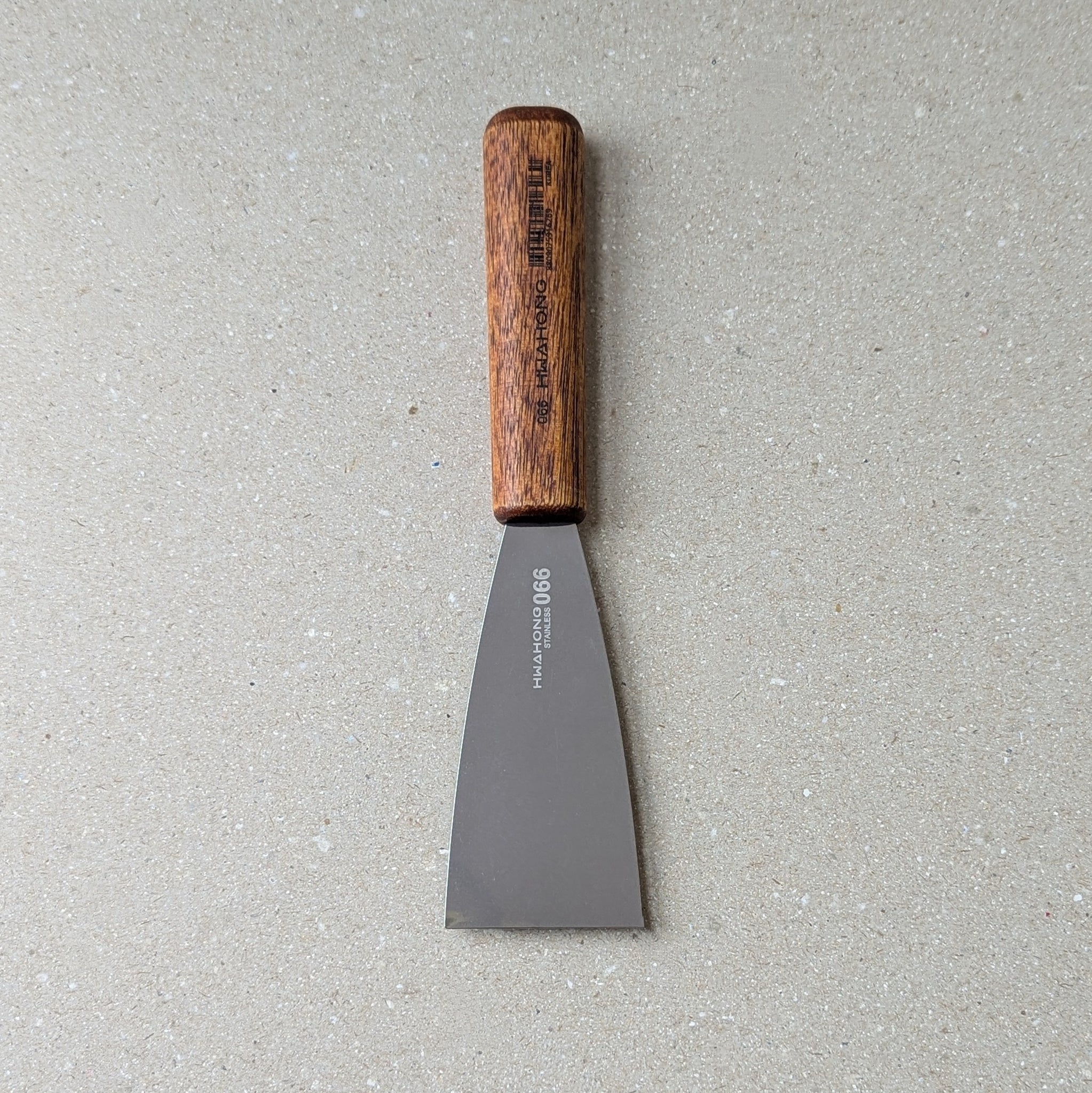 Inking Knife / Spatula with wooden handle on a gray surface