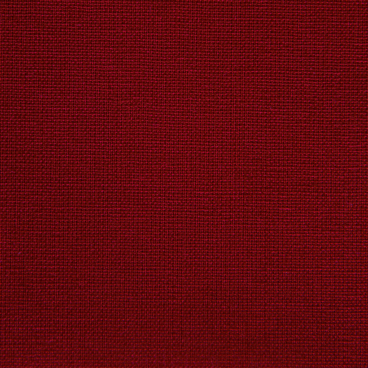 A close-up image of a deep red book cloth with a textured surface.