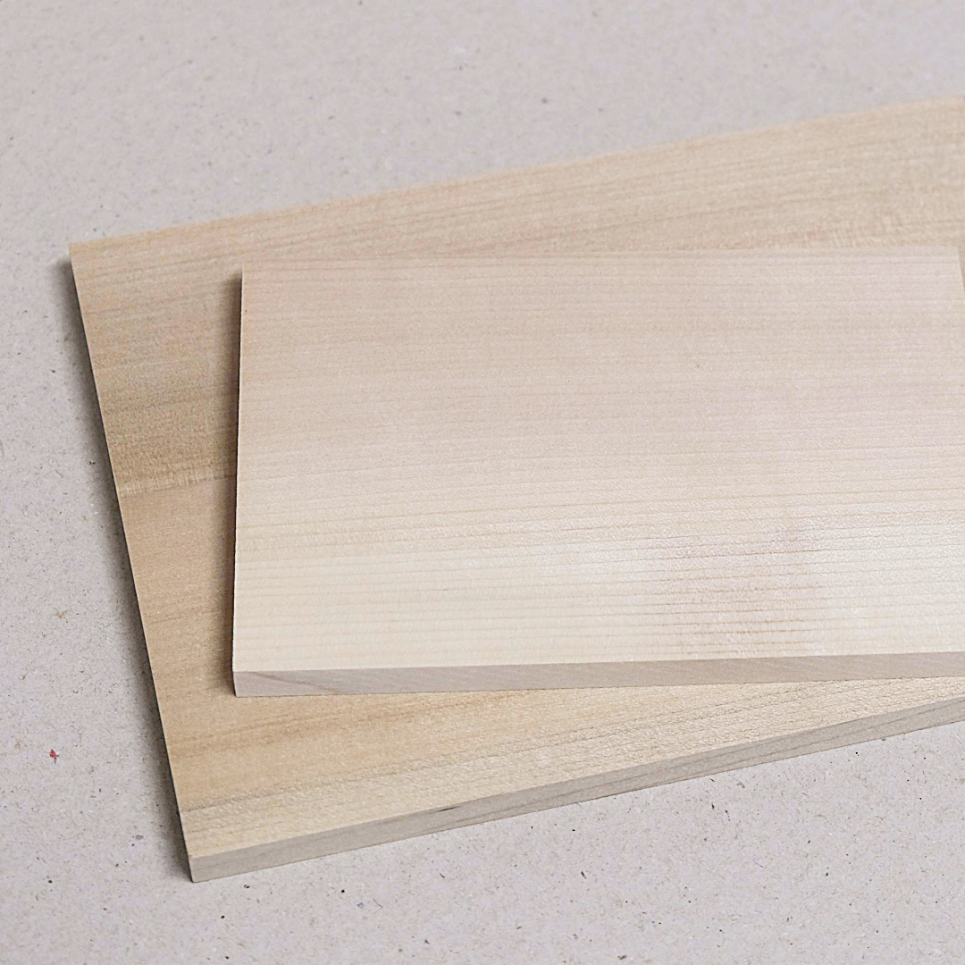 Close up of two Japanese magnolia wood blocks placed one on top of the other on a light background.