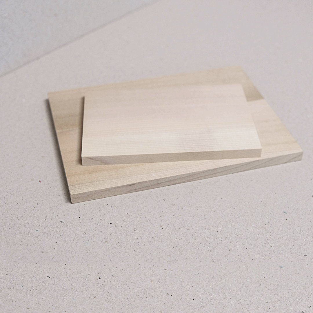Two Japanese magnolia wood blocks placed one on top of the other on a light background.