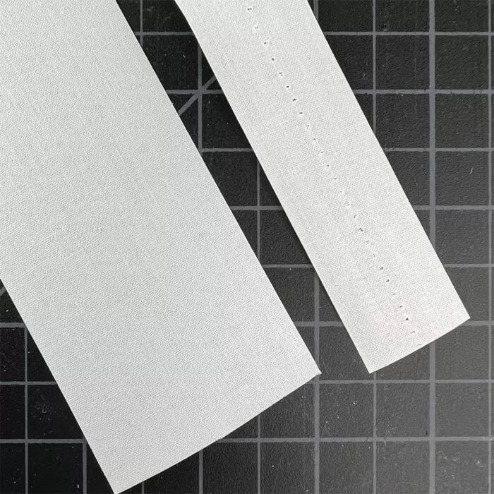Both sizes of Book Repair Tape shown on a green cutting mat.