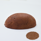 A half egg shaped pastel in a brown tone, sitting on a white background with a drawn colour swatch.