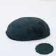 A half egg shaped pastel in a dark blue tone, sitting on a white background with a drawn colour swatch.