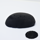 A half egg shaped pastel in black, sitting on a white background with a drawn colour swatch.
