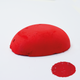 A half egg shaped pastel in a vibrant red tone, sitting on a white background with a drawn colour swatch.