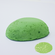 A half egg shaped pastel in a light green tone, sitting on a white background with a drawn colour swatch.