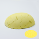 A half egg shaped pastel in a yellow tone, sitting on a white background with a drawn colour swatch.