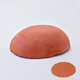 A half egg shaped pastel in a earthy red tone, sitting on a white background with a drawn colour swatch.