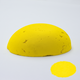 A half egg shaped pastel in a yellow tone, sitting on a white background with a drawn colour swatch.
