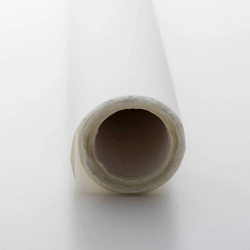 Close-up of a roll of white paper with a white background
