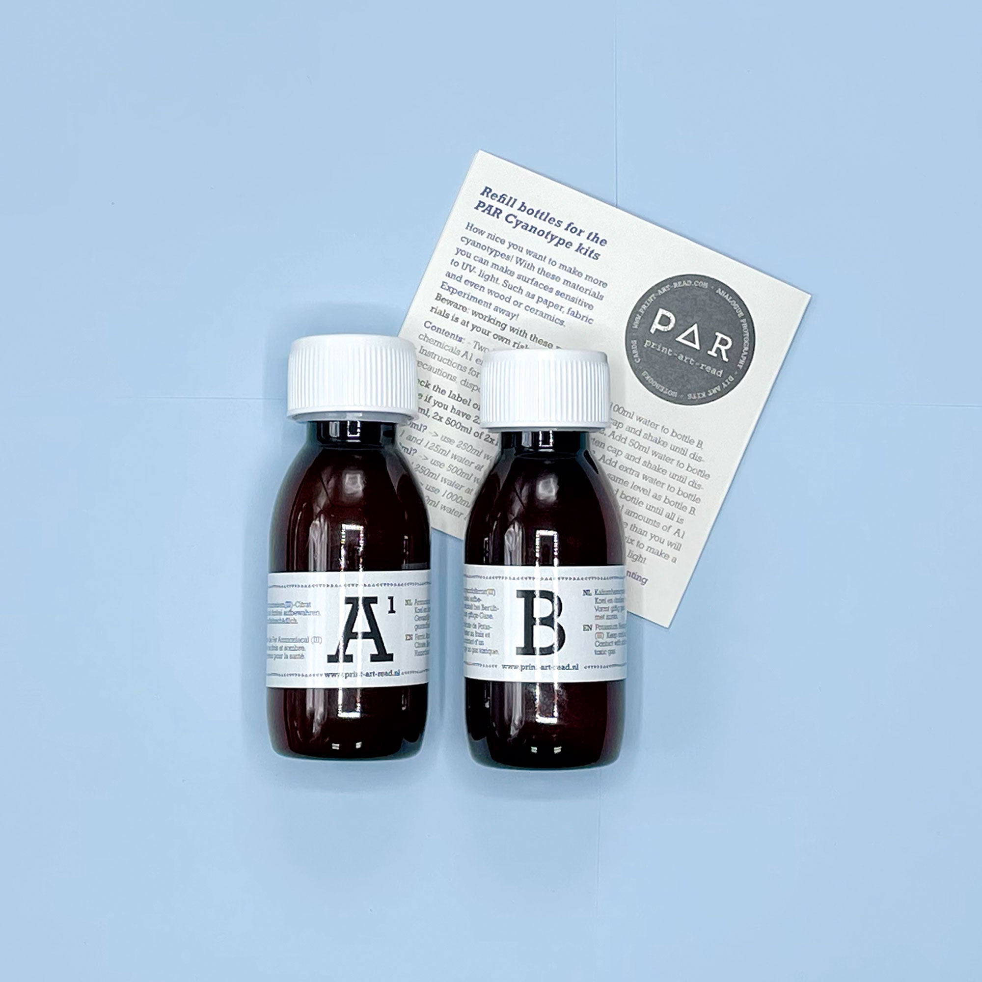 Two brown glass bottles labeled 'A' and 'B' with a white label on a light blue background.