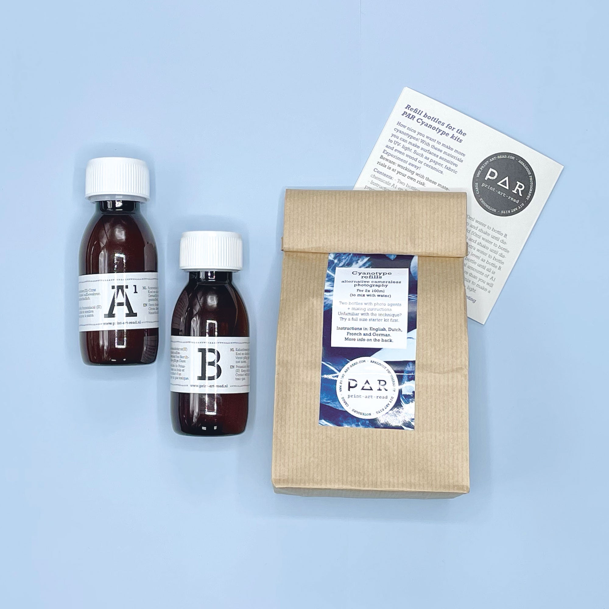 Two glass bottles labelled A and B next to a paper bag and piece of paper with PAR logo's on a light blue background.