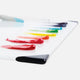 A white glass slab with corner protectors with a range of coloured oil paints swatched on the top and a palette knife with blue paint on the end.