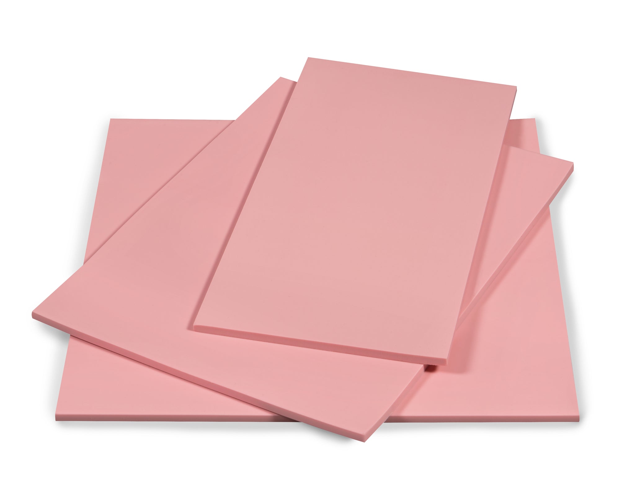 A pile of three pink Speedball Speedy Carve Blocks of various sizes on a white background