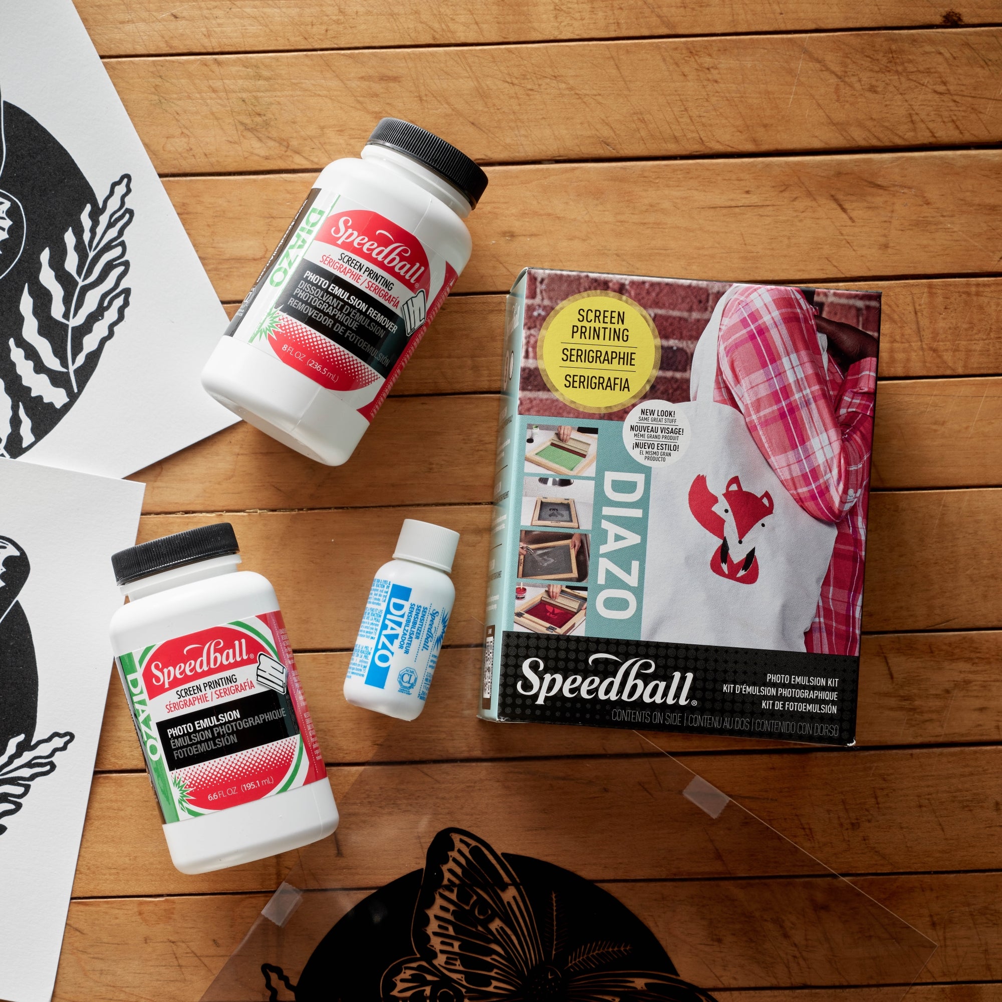 Screen printing supplies including Speedball and DIAZO products on a wooden surface.