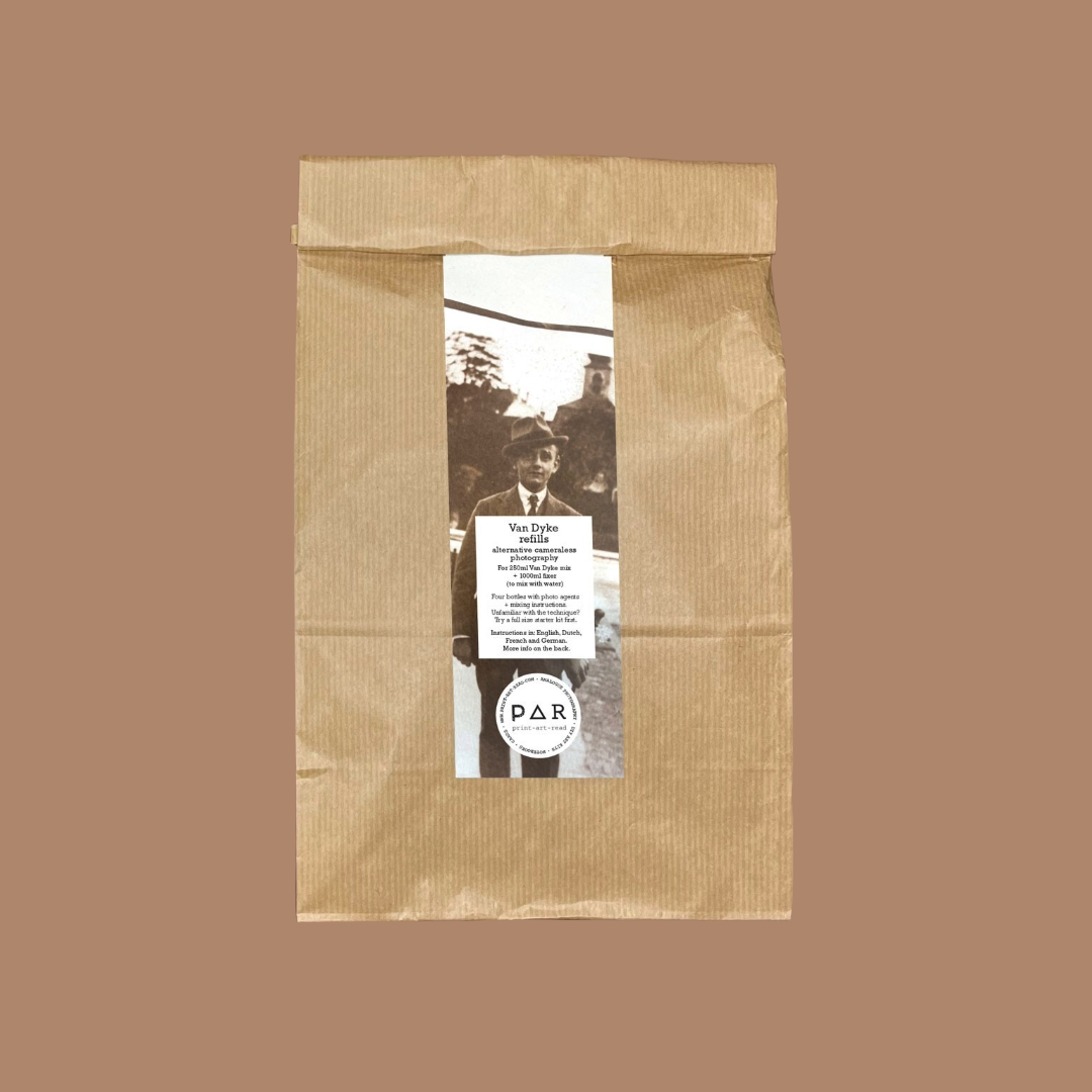 Brown paper bag with a printed label featuring a sepia printed portrait and text on a brown background.