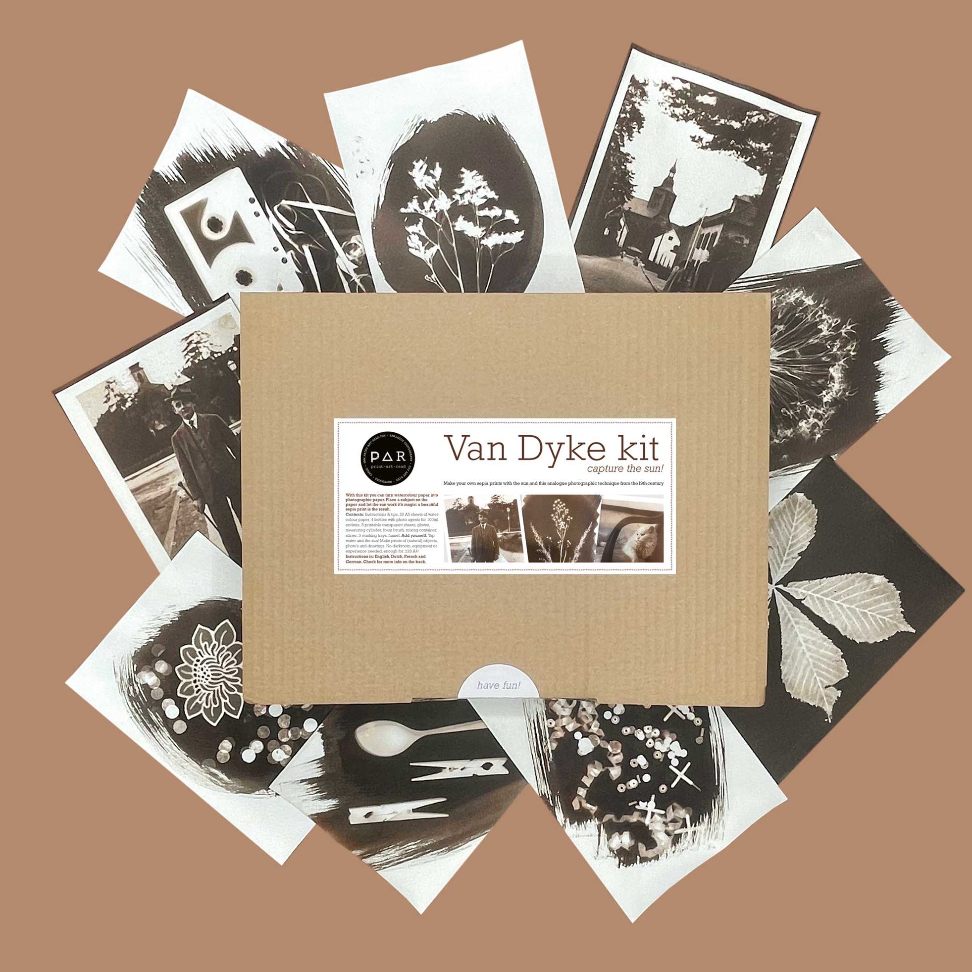 Van Dyke Paper Kit Box surrounded by example exposures on paper