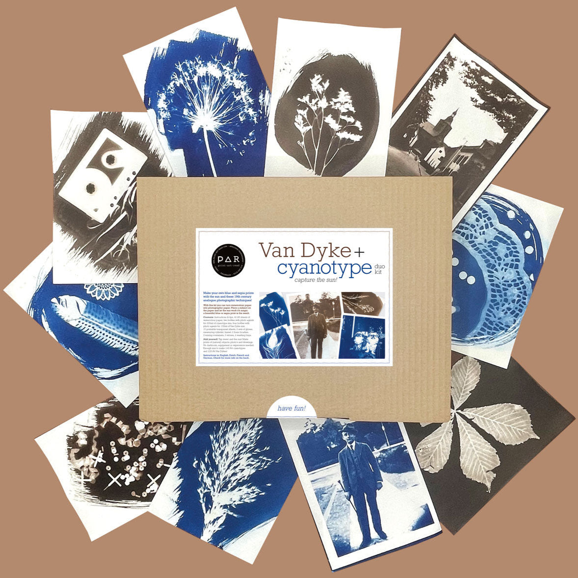 Van Dyke and Cyanotype Duo Paper Kit Box surrounded by example exposures on paper