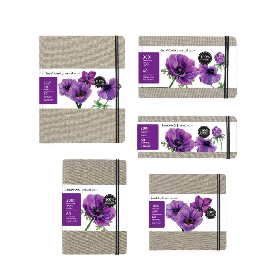 A display of five linen-covered watercolour journals of various sizes with beige textured covers and a floral design on the cover.