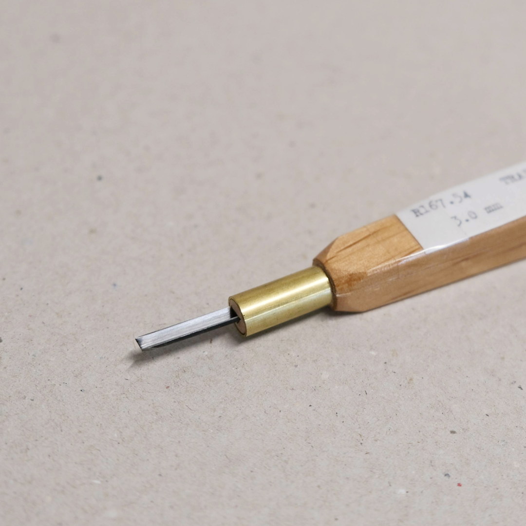 A traditional Japanese 'V' carving tool with a wooden handle, brass ferrule and a high-grade steel blade.