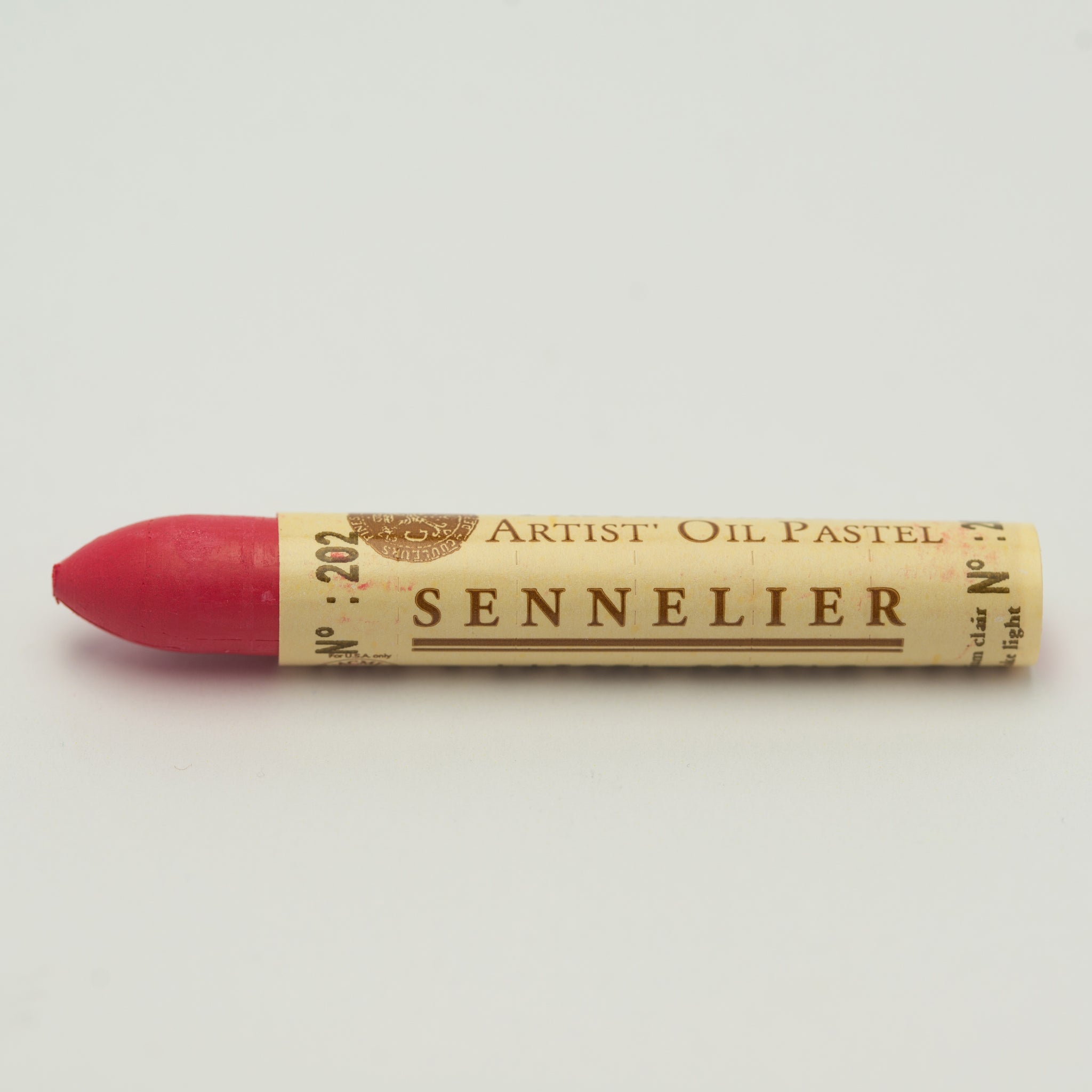 A single Sennelier oil pastel crayon against a white background, displaying the brand name and the words 'Artist Oil Pastel' on the wrapper.