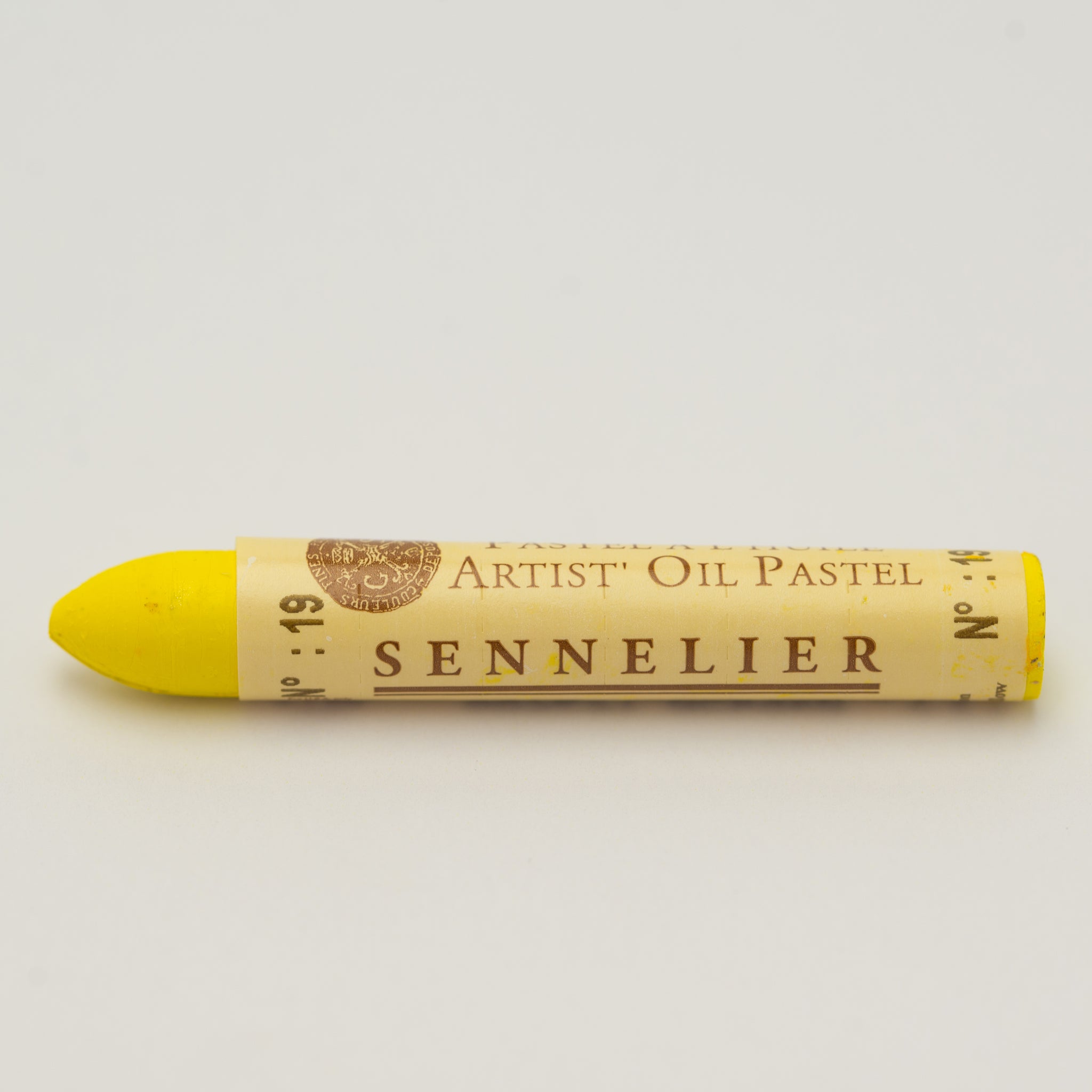 A single Sennelier oil pastel crayon against a white background, displaying the brand name and the words 'Artist Oil Pastel' on the wrapper.