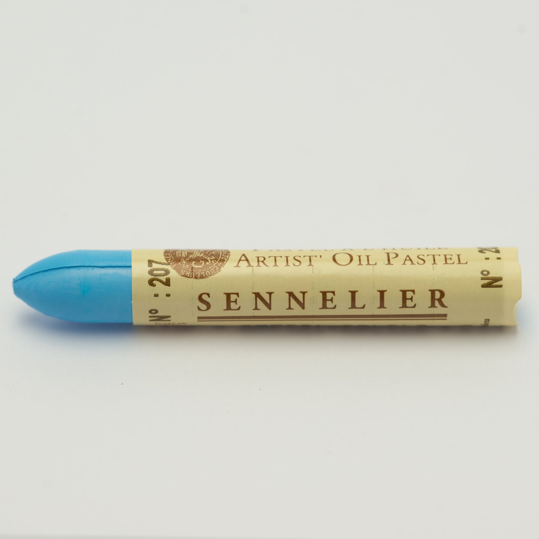 A single Sennelier oil pastel crayon against a white background, displaying the brand name and the words 'Artist Oil Pastel' on the wrapper.