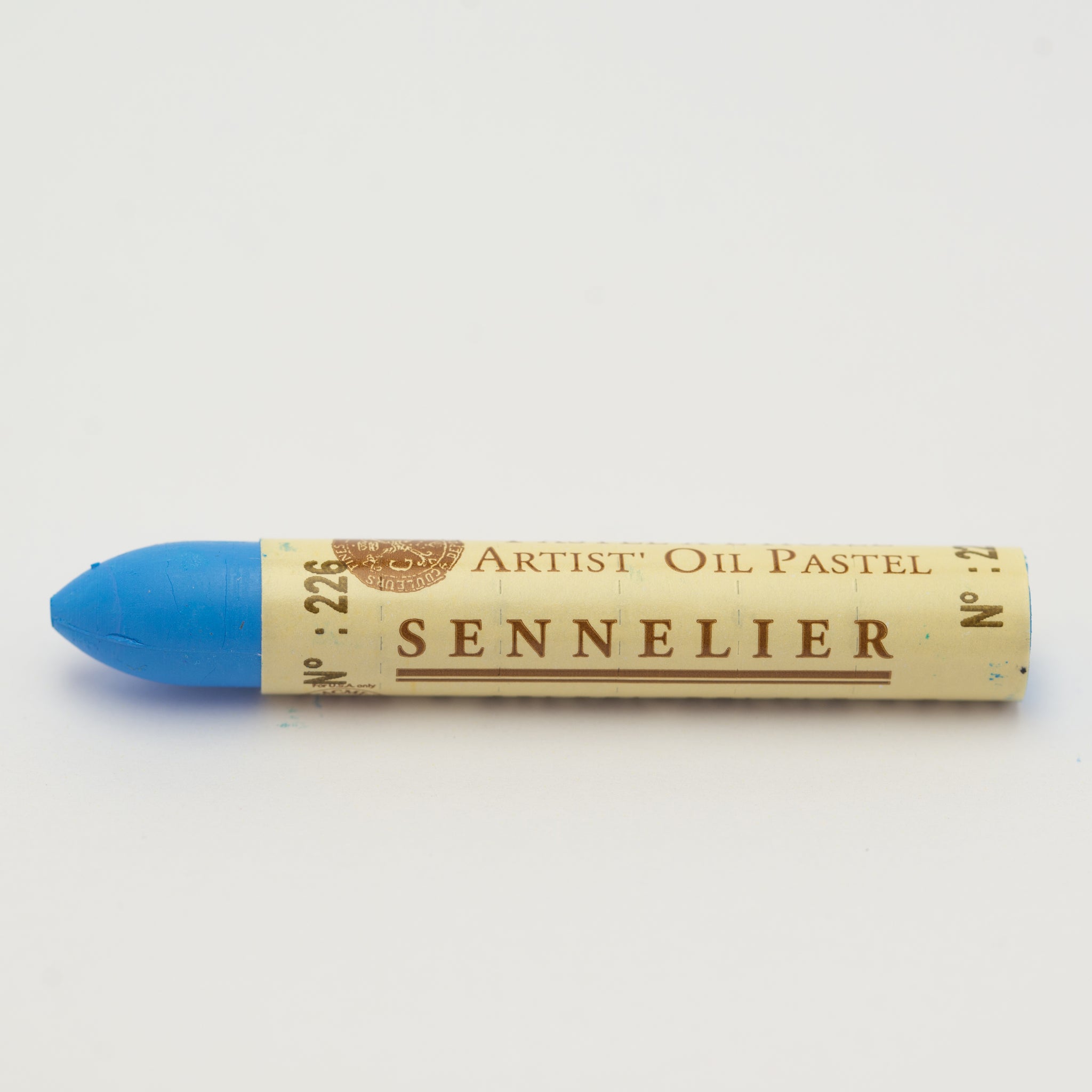 A single Sennelier oil pastel crayon against a white background, displaying the brand name and the words 'Artist Oil Pastel' on the wrapper.