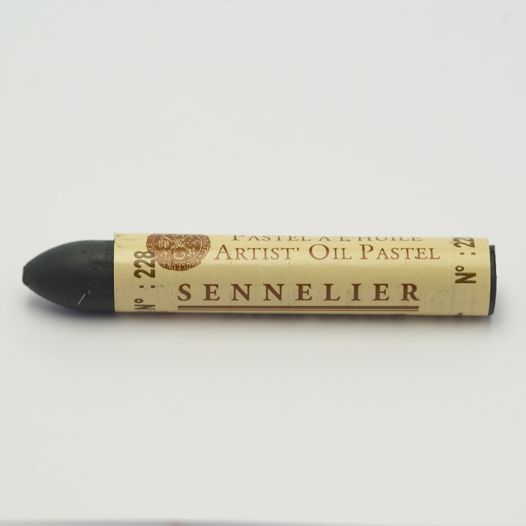 A single Sennelier oil pastel crayon against a white background, displaying the brand name and the words 'Artist Oil Pastel' on the wrapper.