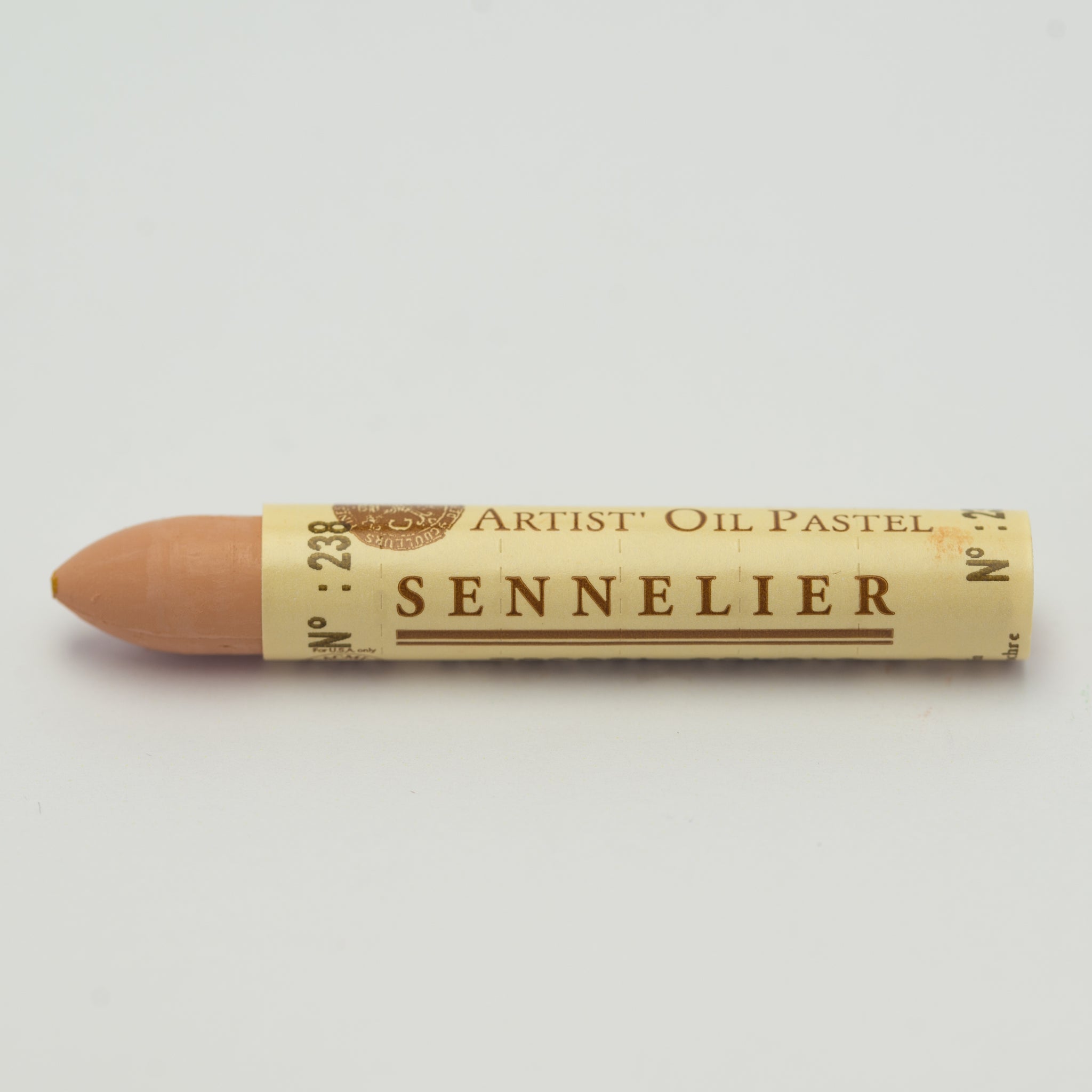 A single Sennelier oil pastel crayon against a white background, displaying the brand name and the words 'Artist Oil Pastel' on the wrapper.