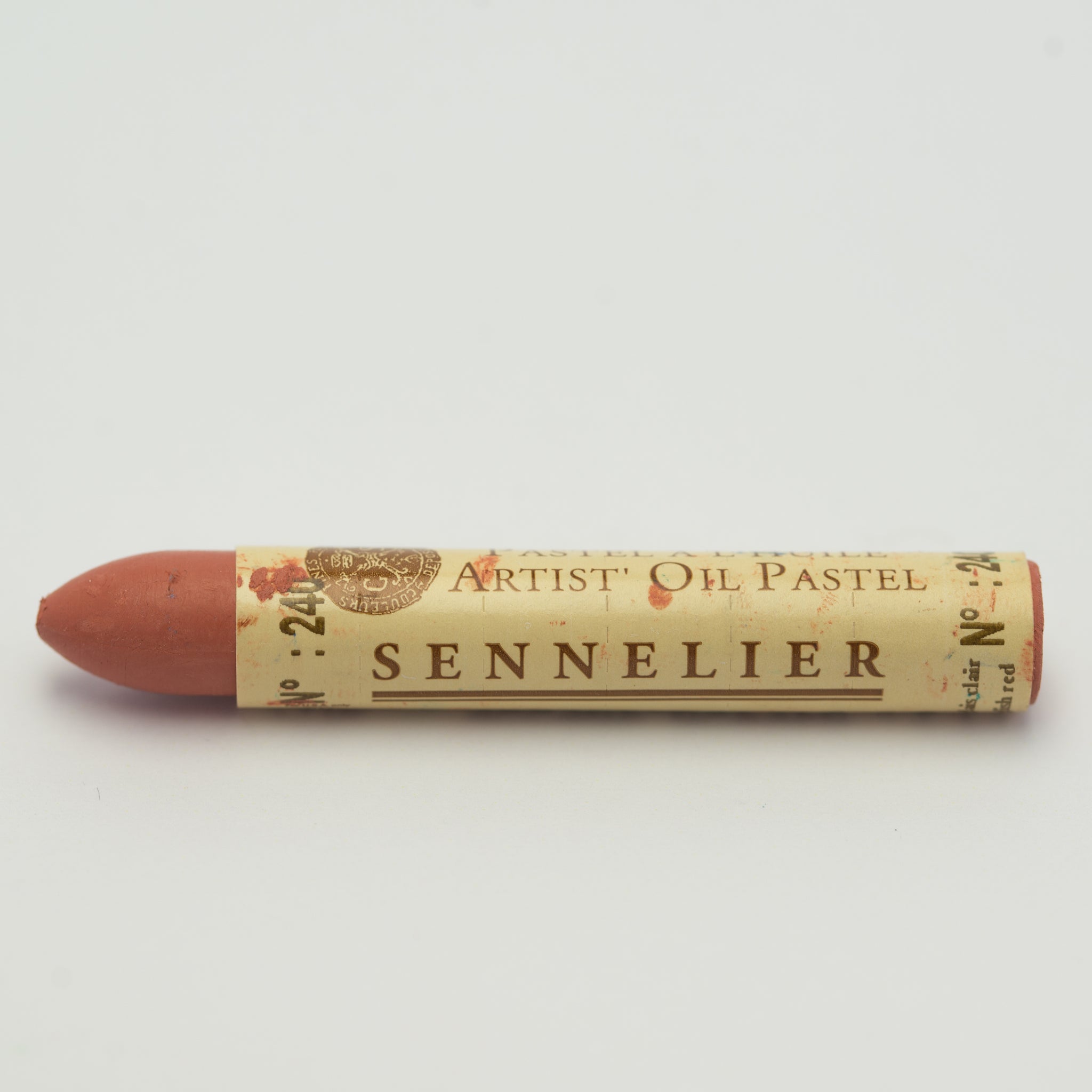 A single Sennelier oil pastel crayon against a white background, displaying the brand name and the words 'Artist Oil Pastel' on the wrapper.